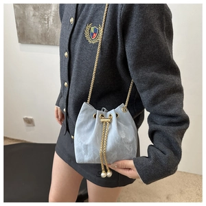 Light blue marble bucket bag with golden chain strap and pearl drawstring details