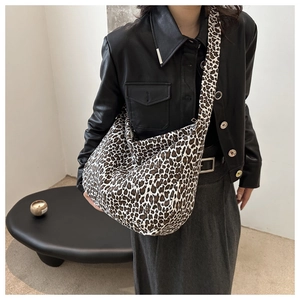 Close-up of stylish leopard print tote bag styled with an autumn streetwear outfit