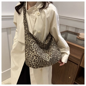 Detail of leopard print canvas tote bag featuring large capacity and wide shoulder strap