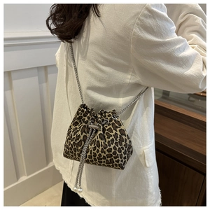 Detailed view of leopard print bucket bag with silver chain strap and pearl drawstring