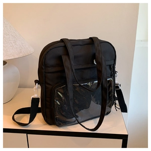 Detail of black nylon tote bag with clear PVC pocket and adjustable wide shoulder strap