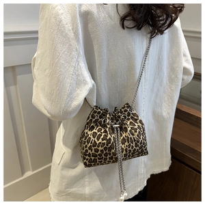 Detail of leopard print bucket bag with silver chain strap and pearl accents