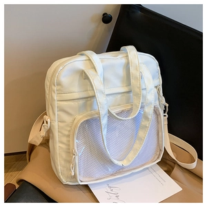Detail of off-white tote bag featuring a transparent mesh front pocket and durable handles