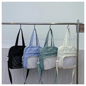 Detail showing various colors of large capacity shoulder bags with mesh front pockets