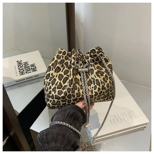 Detail of leopard print bucket bag with silver chain and pearl drawstring charms