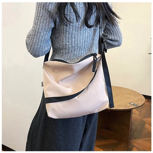 Vue arrière du mannequin portant un sac fourre-tout minimaliste en nylon beige chic