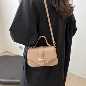 French vintage beige underarm bag with lychee texture and gold buckle on a model