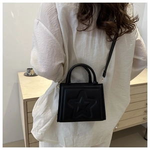 Detailed back view of a black mini crossbody bag with embossed star pattern for women