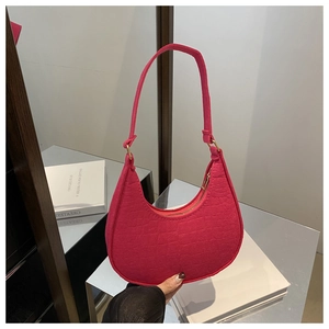 Close-up of hot pink crocodile embossed hobo bag with sleek golden zipper detail