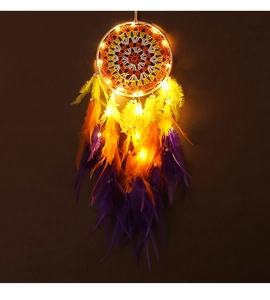 Detail of a handmade dream catcher featuring colorful feathers and warm glowing LED lights