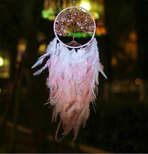 Close-up of pink crystal Tree of Life dream catcher with soft feathers and beads