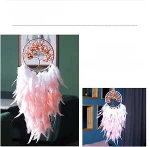 Macro shot of the tree of life dreamcatcher with pink feathers and natural stone beads