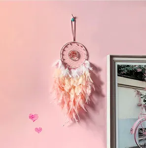 Detailed view of pink dream catcher with Tree of Life wire weave and soft feathers