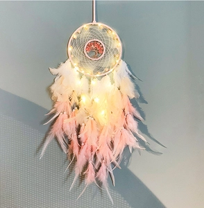 Detail of pink and white feather dreamcatcher with LED lights and Tree of Life motif