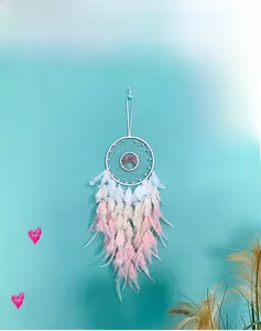 Detail of tree of life dreamcatcher with pink gradient feathers and pearl beads