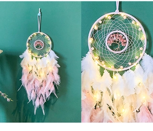 Detail of life tree dream catcher with gradient feathers and glowing LED lights