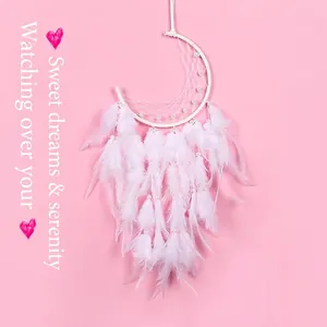 White moon dream catcher with delicate feathers and pearls on a soft pink background