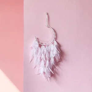 White feather dreamcatcher with moon-shaped silver metal frame and delicate bead details
