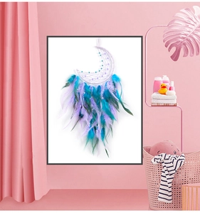 Macro detail of moon-shaped dream catcher with gradient feathers and beadwork