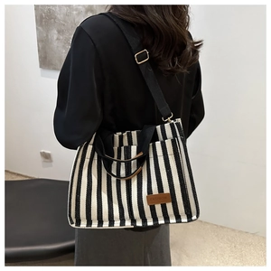 Vertical striped canvas tote bag with fashion leather label and adjustable strap