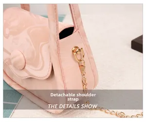 Detail of pink marble handbag with detachable gold chain strap and D-ring buckle