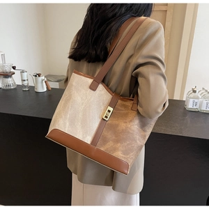 Detail of vintage canvas tote bag showing contrast textures and metal buckle hardware