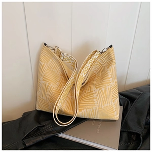 Detail of jacquard crossbody bag with geometric patterns and broad shoulder strap