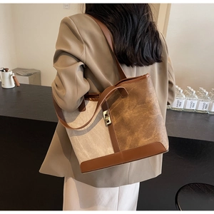 Minimalist canvas and faux leather patchwork tote bag styled on model in minimalist interior