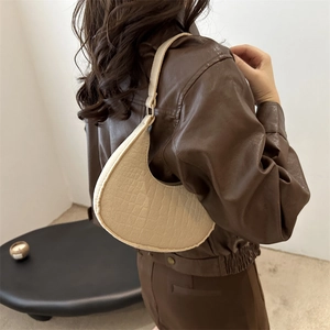 Minimalist apricot crescent underarm bag with crocodile pattern leather on model