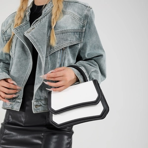 Elegant black and white contrast leather handbag for women featuring a minimalist square design