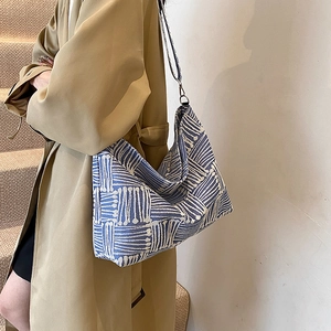 Minimalist blue and white geometric hobo bag with large capacity and soft texture