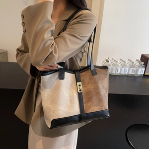 Retro color-block tote bag with black leather straps and golden metal square buckle