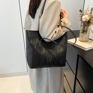 Black large capacity tote bag with vertical textured stripes and slender shoulder straps
