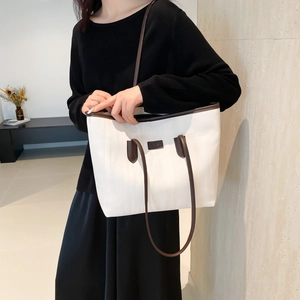 Minimalist white tote bag with dark brown leather straps for commuting and daily wear