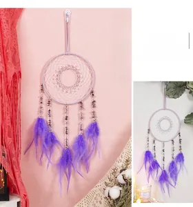 Detailed view of handmade purple dream catcher with amethyst stones and soft feathers