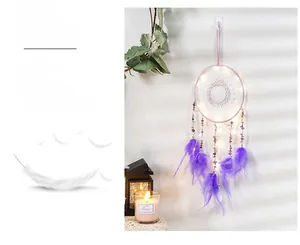 Detail view of purple dream catcher with warm LED lights and hanging feathers