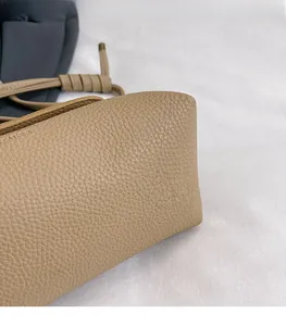 Close-up of genuine leather texture with pebble grain and embossed brand lettering