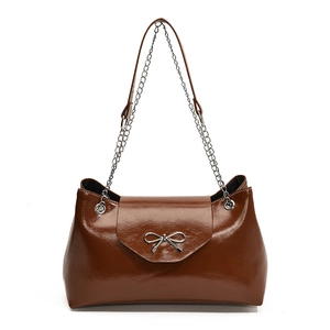 Elegant brown patent leather tote bag with silver bow accent and chain strap for work