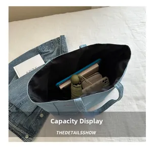 Detail view of large capacity denim tote bag showing interior storage for daily items