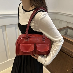 Chic red patent leather handbag with dual pockets and sleek shoulder straps for women