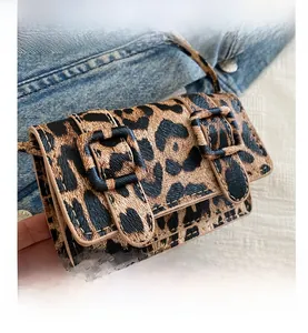 Detailed view of leopard print mini bag with double buckle straps and fine stitching