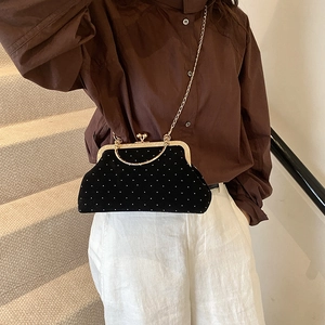 Elegant black velvet shell bag with white polka dots and gold chain strap