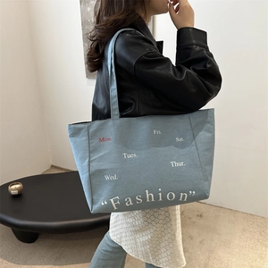 Large blue denim tote bag with weekly schedule print for daily commuting fashion