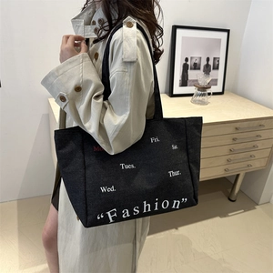 Minimalist black canvas tote bag with fashion print and daily schedule art for women