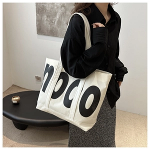 Detail shot of white large tote bag with mood letter print and wide shoulder strap