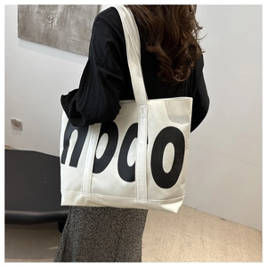 Detail view of large tote bag with NPCO lettering print on high-quality white faux leather