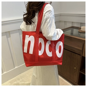 Large capacity red tote bag with white letter print and wide strap for daily commute
