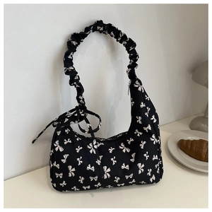 Black crescent handbag with white bow prints and gathered handle for a vintage look