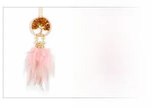 Detail of Tree of Life dreamcatcher with amber stones and soft pink feathers