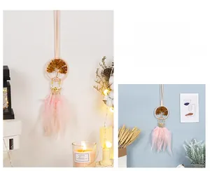 Detail of pink feather dreamcatcher with tree of life metal crown and gemstone beads